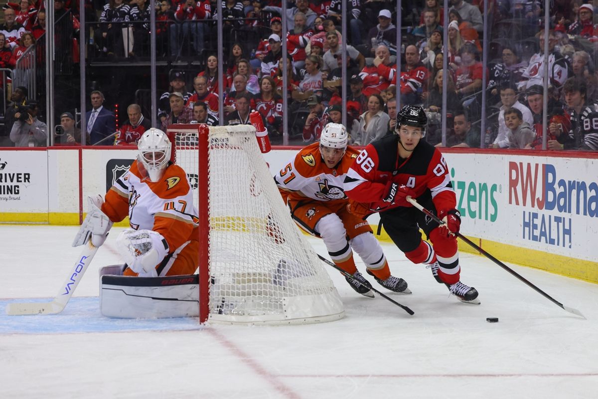 Oct 27, 2024; Newark, New Jersey, USA; New Jersey Devils center Jack Hughes (86) skates with the puck while being defended by Anaheim Ducks defenseman Olen Zellweger (51) during the second period at Prudential Center. Mandatory Credit: Ed Mulholland-Imagn Images