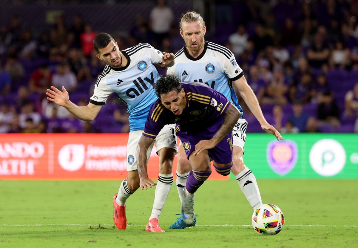 Oct 27, 2024; Orlando, Florida, USA; Orlando City midfielder Facundo Torres (10) dribbles against Charlotte FC midfielder Jamie Paterson (7) and defender Tim Ream (3) during the first half in a 2024 MLS Cup Playoffs Round One match at Inter&Co Stadium. Mandatory Credit: Kim Klement Neitzel-Imagn Images