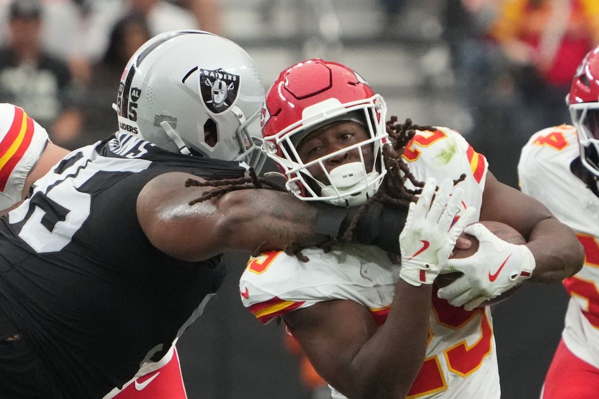 Oct 27, 2024; Paradise, Nevada, USA; Kansas City Chiefs running back Clyde Edwards-Helaire (25) is tackled by Las Vegas Raiders defensive tackle John Jenkins (95)  in the first half at Allegiant Stadium. Mandatory Credit: Kirby Lee-Imagn Images