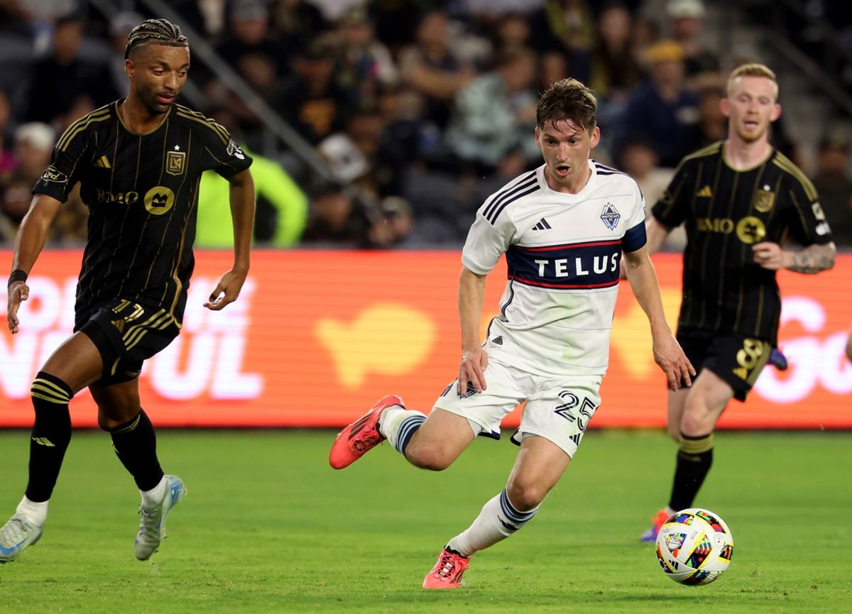 Oct 27, 2024; Los Angeles, California, USA; Vancouver Whitecaps FC midfielder Ryan Gauld (25) dribbles against LAFC midfielder Timothy Tillman (11) during the first half in a 2024 MLS Cup Playoffs Round One match at BMO Stadium. Mandatory Credit: Kiyoshi Mio-Imagn Images