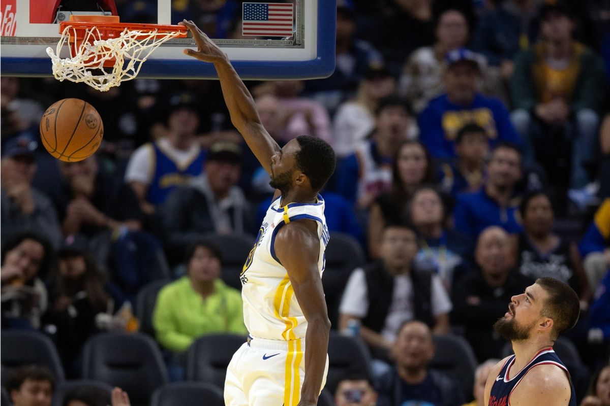 Oct 27, 2024; San Francisco, California, USA; Golden State Warriors forward Andrew Wiggins (22) dunks ahead of Los Angeles Clippers center Ivica Zubac (40) during the third quarter at Chase Center. Mandatory Credit: D. Ross Cameron-Imagn Images