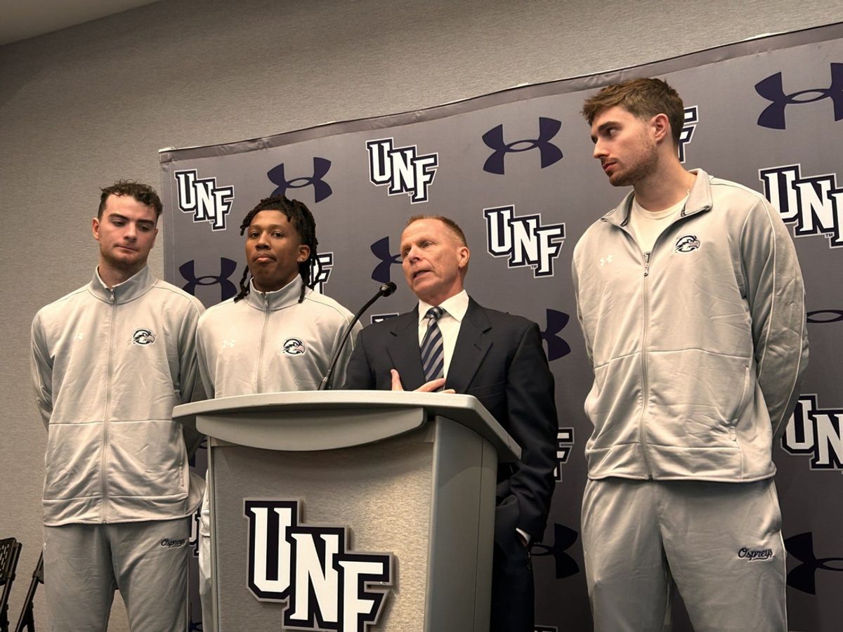 University of North Florida basetball coach Matthew Driscoll (second from the right) talks about the upcoming season during UNF's media day on Oct. 22.