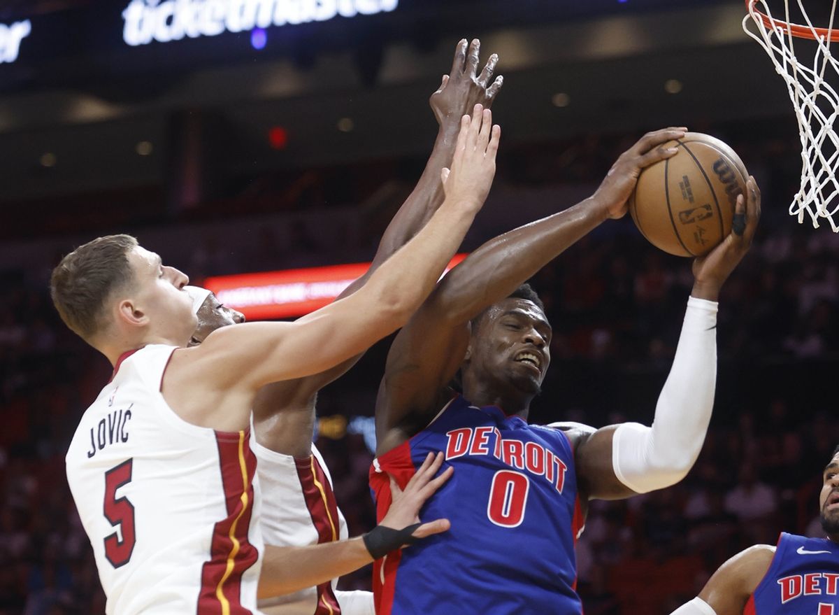 Oct 28, 2024; Miami, Florida, USA; Detroit Pistons center Jalen Duren (0) grabs a rebound over Miami Heat forward Nikola Jovic (5) at Kaseya Center. Mandatory Credit: Rhona Wise-Imagn Images