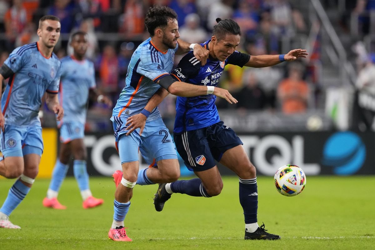 Oct 28, 2024; Cincinnati, Ohio, USA; New York City FC forward Kevin O'Toole (22) battles FC Cincinnati forward Yuya Kubo (7) for the ball in the first half in a 2024 MLS Cup Playoffs Round One match at  TQL Stadium. Mandatory Credit: Kareem Elgazzar-Imagn Images