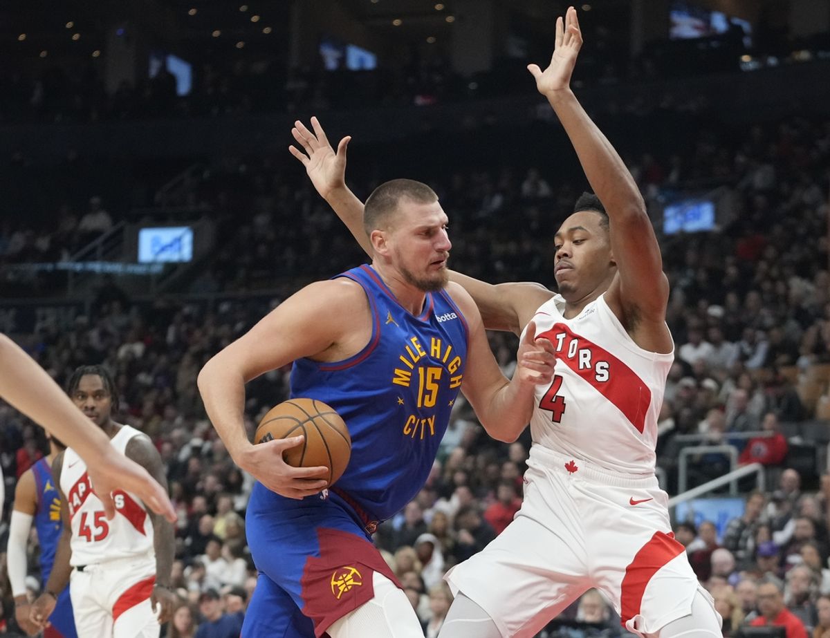 Oct 28, 2024; Toronto, Ontario, CAN; Denver Nuggets center Nikola Jokic (15) drives to the net against Toronto Raptors forward Scottie Barnes (4) during the first half at Scotiabank Arena. Mandatory Credit: John E. Sokolowski-Imagn Images