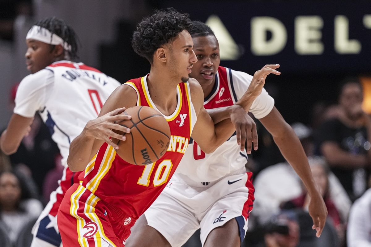 Oct 28, 2024; Atlanta, Georgia, USA; Atlanta Hawks forward Zaccharie Risacher (10) dribbles against Washington Wizards guard Carlton Carrington (8) during the first half at State Farm Arena. Mandatory Credit: Dale Zanine-Imagn Images