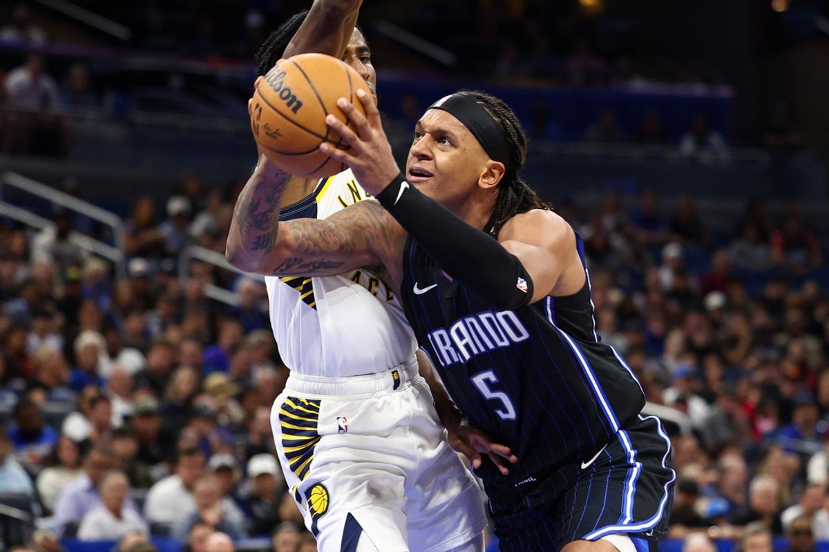 Oct 28, 2024; Orlando, Florida, USA; Orlando Magic forward Paolo Banchero (5) drives to the hoop past Indiana Pacers forward Aaron Nesmith (23) in the second quarter at Kia Center. Mandatory Credit: Nathan Ray Seebeck-Imagn Images