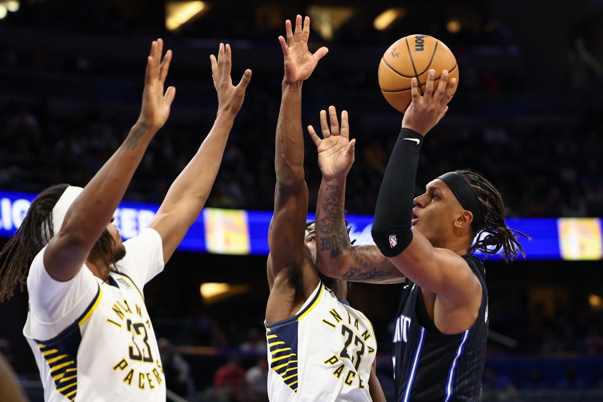 Oct 28, 2024; Orlando, Florida, USA; Orlando Magic forward Paolo Banchero (5) drives to the hoop past Indiana Pacers forward Aaron Nesmith (23) in the second quarter at Kia Center. Mandatory Credit: Nathan Ray Seebeck-Imagn Images