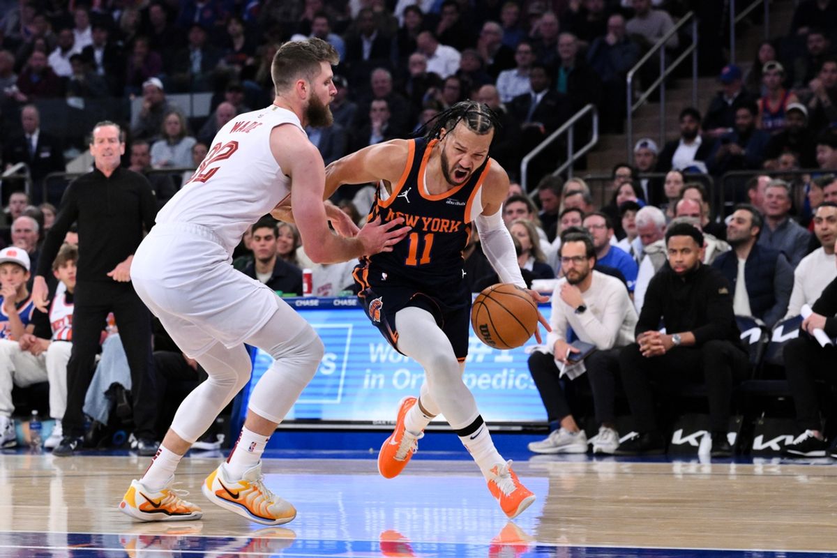 Oct 28, 2024; New York, New York, USA; New York Knicks guard Jalen Brunson (11) drives to the basket while being defended by Cleveland Cavaliers forward Dean Wade (32) during the first half at Madison Square Garden. Mandatory Credit: John Jones-Imagn Images