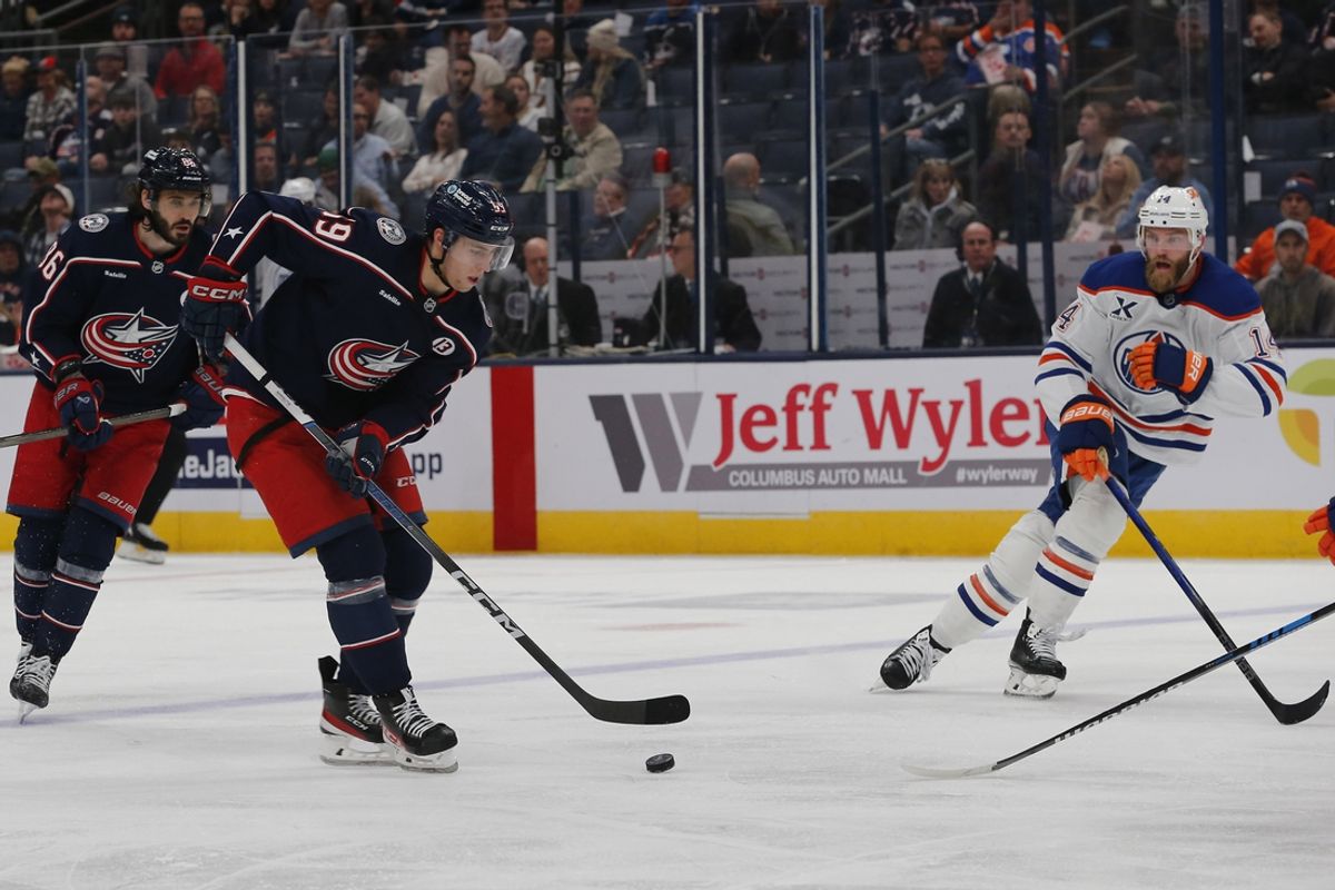 Oct 28, 2024; Columbus, Ohio, USA; Columbus Blue Jackets center Adam Fantilli (19) carries the puck as Edmonton Oilers defenseman Mattias Ekholm (14) defends during the second period at Nationwide Arena. Mandatory Credit: Russell LaBounty-Imagn Images