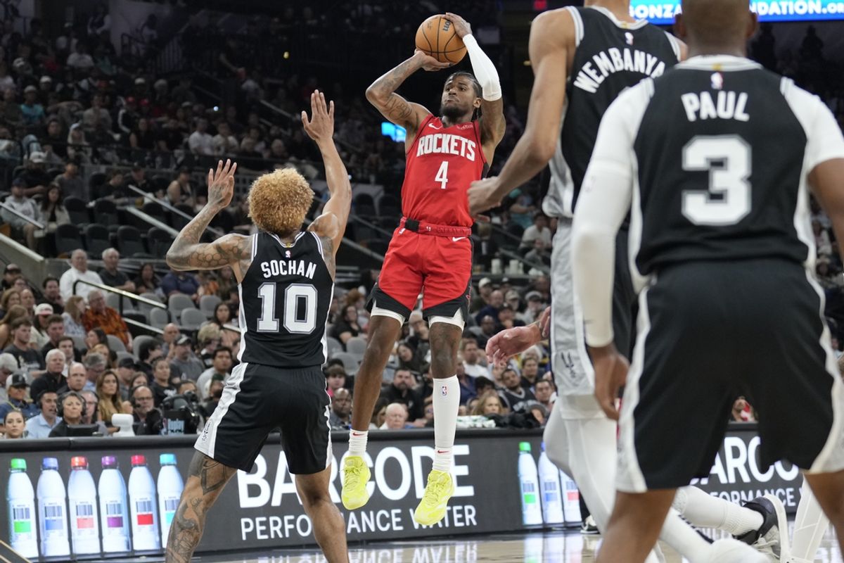 Oct 28, 2024; San Antonio, Texas, USA; Houston Rockets guard Jalen Green (4) shoots over San Antonio Spurs forward Jeremy Sochan (10) during the first half at Frost Bank Center. Mandatory Credit: Scott Wachter-Imagn Images