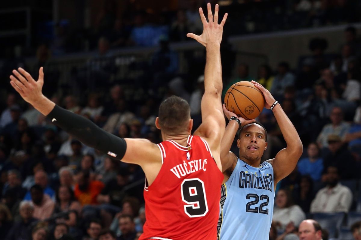 Oct 28, 2024; Memphis, Tennessee, USA; Memphis Grizzlies guard Desmond Bane (22) shoots a three point basket as Chicago Bulls center Nikola Vucevic (9) defends during the first half at FedExForum. Mandatory Credit: Petre Thomas-Imagn Images