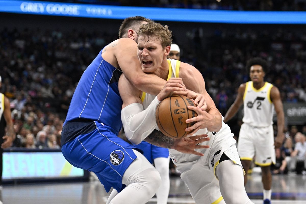 Oct 28, 2024; Dallas, Texas, USA; Dallas Mavericks guard Luka Doncic (77) attempts to the knock the ball away from Utah Jazz forward Lauri Markkanen (23) during the second quarter at the American Airlines Center. Mandatory Credit: Jerome Miron-Imagn Images