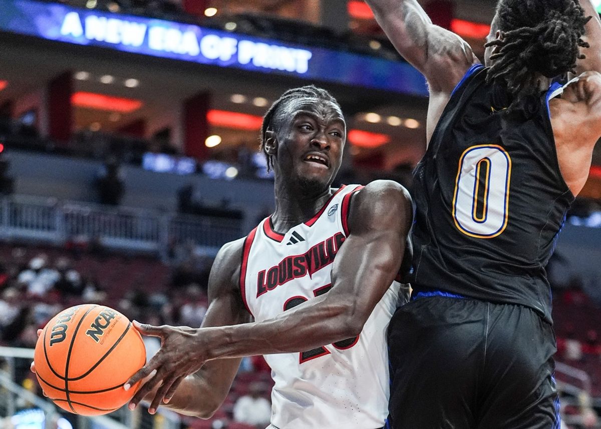 Louisville Cardinals forward Aboubacar Traore (25) looks to pass around Spalding University's Caden Bradford (0) at the KFC Yum! Center in Louisville, Kentucky Monday, Oct. 28, 2024.