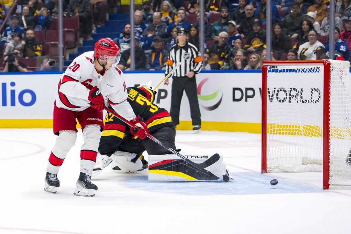 Oct 28, 2024; Vancouver, British Columbia, CAN; Carolina Hurricanes forward Sebastian Aho (20) scores the game winning goal on Vancouver Canucks goalie Kevin Lankinen (32) in overtime at Rogers Arena. Mandatory Credit: Bob Frid-Imagn Images