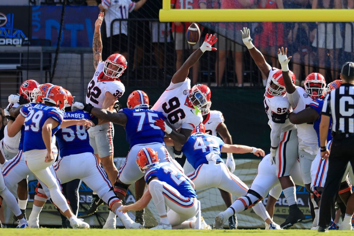 Georgia defensive linemen Zion Logue (96) and Warren Brinson (97), and linebacker Chaz Chambliss (32) can't stop a PAT try from Florida's Trey Smack (29) during a game Saturday, Oct. 28, 2023 in Jacksonville, Fla. Georgia won 43-20. [Corey Perrine/Florida Times-Union]