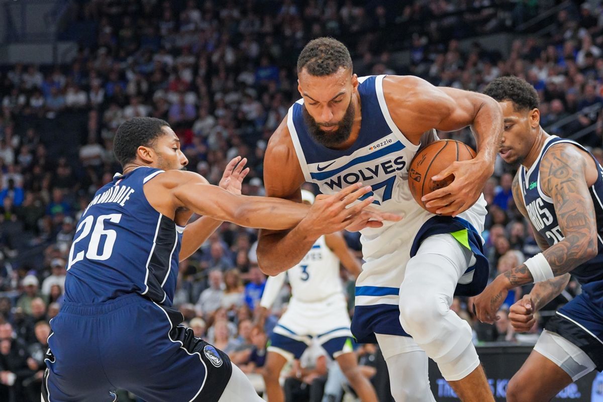 Oct 29, 2024; Minneapolis, Minnesota, USA; Minnesota Timberwolves center Rudy Gobert (27) grabs a loose ball against the Dallas Mavericks guard Spencer Dinwiddie (26) in the first quarter at Target Center. Mandatory Credit: Brad Rempel-Imagn Images