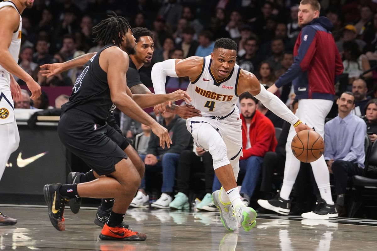 Oct 29, 2024; Brooklyn, New York, USA; Denver Nuggets point guard Russell Westbrook (4) dribbles the ball against Brooklyn Nets small guard Cam Thomas (24) during the first half at Barclays Center. Mandatory Credit: Gregory Fisher-Imagn Images