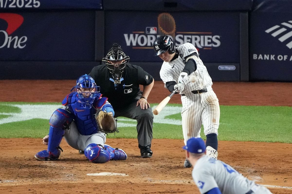 Oct 29, 2024; Bronx, New York, USA; New York Yankees shortstop Anthony Volpe (11) hits a grand slam against the Los Angeles Dodgers in the third inning during game four of the 2024 MLB World Series at Yankee Stadium. Mandatory Credit: Robert Deutsch-Imagn Images