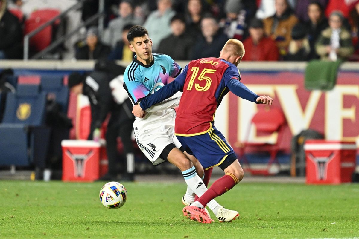 Oct 29, 2024; Sandy, Utah, USA; Minnesota United midfielder Joaquin Pereyra (26) and Real Salt Lake defender Justen Glad (15) battle for the ball in the second half in a 2024 MLS Cup Playoffs Round One match at America First Field. Mandatory Credit: Jamie Sabau-Imagn Images