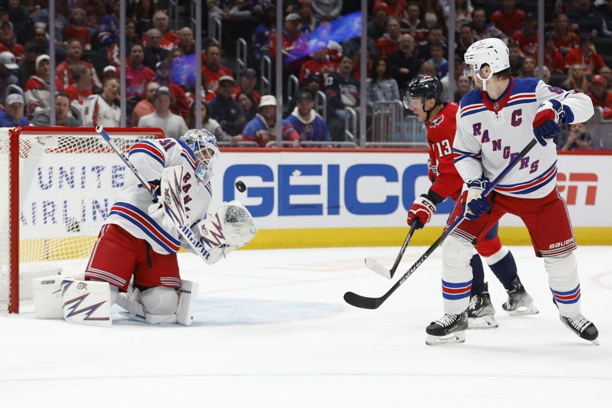 Oct 29, 2024; Washington, District of Columbia, USA; New York Rangers goaltender Igor Shesterkin (31) makes a save on Washington Capitals left wing Jakub Vrana (13) as Rangers defenseman Jacob Trouba (8) defends in the first period at Capital One Arena. Mandatory Credit: Geoff Burke-Imagn Images