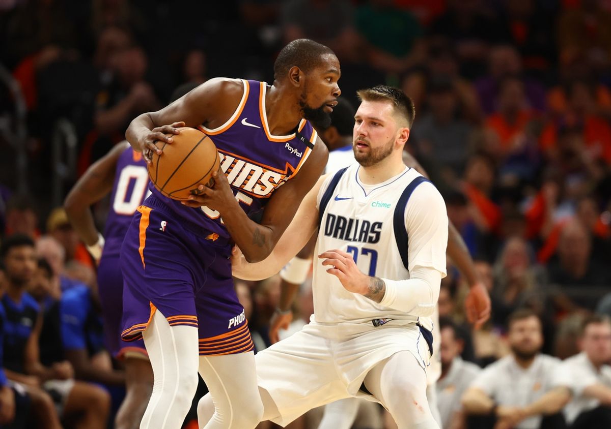 Oct 26, 2024; Phoenix, Arizona, USA; Dallas Mavericks guard Luka Doncic (77) against Phoenix Suns forward Kevin Durant (35) at Footprint Center. Mandatory Credit: Mark J. Rebilas-Imagn Images