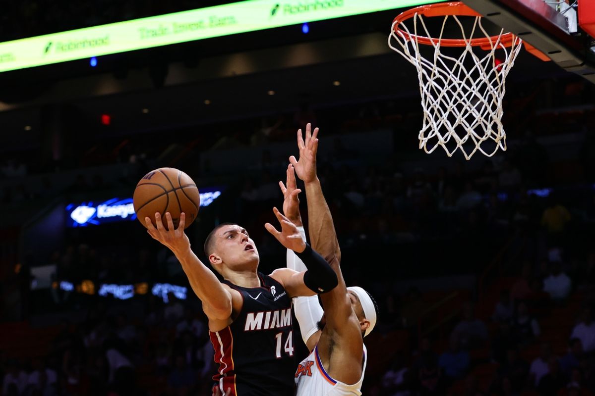 Oct 30, 2024; Miami, Florida, USA; Miami Heat guard Tyler Herro (14) drives to the basket against New York Knicks guard Josh Hart (3) during the first quarter at Kaseya Center. Mandatory Credit: Sam Navarro-Imagn Images