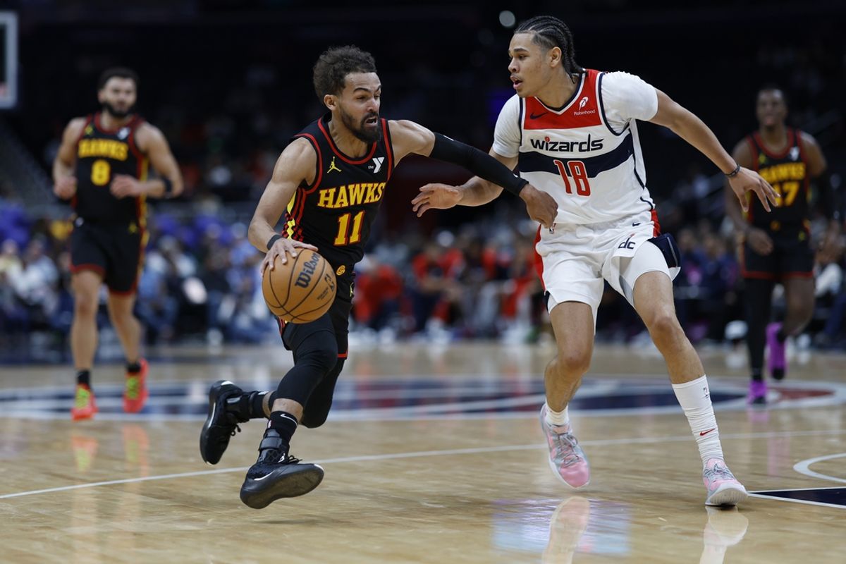 Oct 30, 2024; Washington, District of Columbia, USA; Atlanta Hawks guard Trae Young (11) drives to the basket as Washington Wizards forward Kyshawn George (18) defends in the first half at Capital One Arena. Mandatory Credit: Geoff Burke-Imagn Images