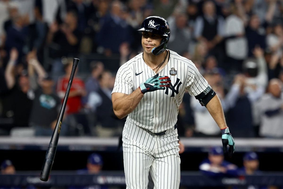 Oct 30, 2024; New York, New York, USA; New York Yankees designated hitter Giancarlo Stanton (27) reacts after hitting a home run during the third inning against the Los Angeles Dodgers in game five of the 2024 MLB World Series at Yankee Stadium. Mandatory Credit: Vincent Carchietta-Imagn Images
