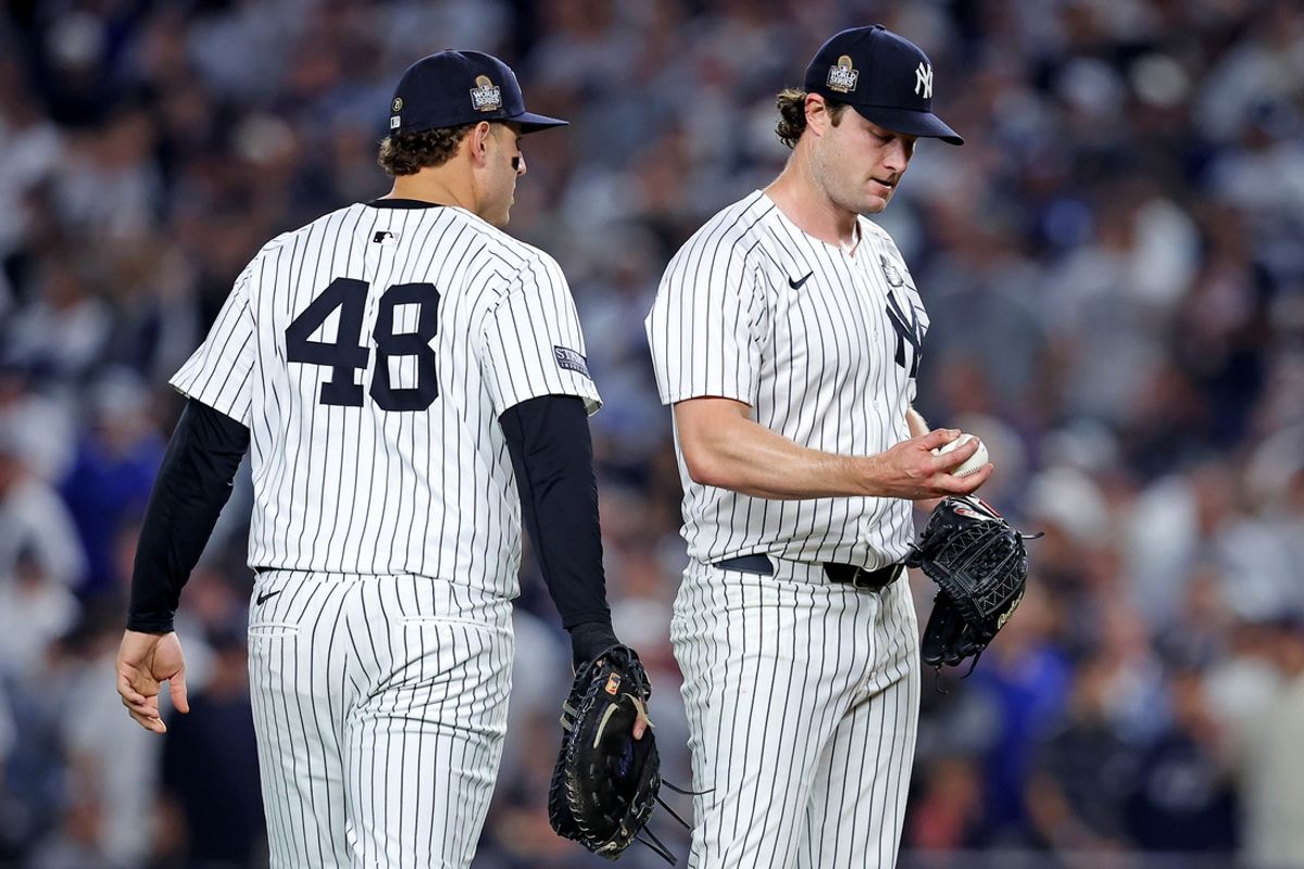 Oct 30, 2024; New York, New York, USA; New York Yankees first baseman Anthony Rizzo (48) talks to pitcher Gerrit Cole (45) during the fifth inning against the Los Angeles Dodgers in game four of the 2024 MLB World Series at Yankee Stadium. Mandatory Credit: Brad Penner-Imagn Images