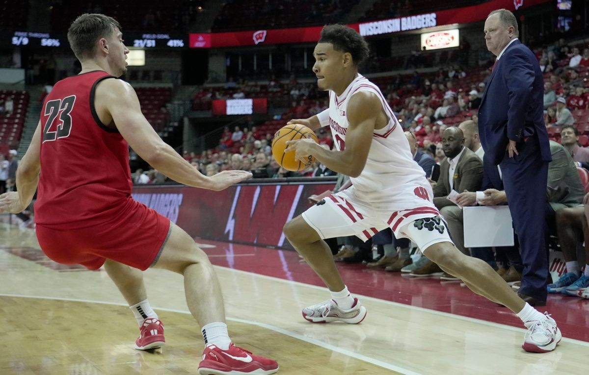 Wisconsin guard John Tonje (9) makes a move on UW-River Falls guard Zac Johnson (23) during the second half of their preseason game Wednesday, October 30, 2024 at the Kohl Center in Madison, Wisconsin. Wisconsin beat UW-River Falls 78-62.