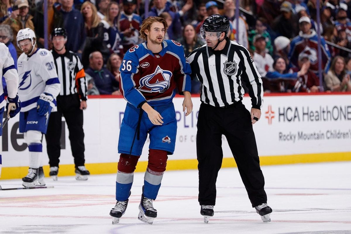 Oct 30, 2024; Denver, Colorado, USA; Colorado Avalanche center Matt Stienburg (36) is escorted off the ice by linesman Brandon Gawryletz (64) after receiving a game misconduct in the second period against the Tampa Bay Lightning at Ball Arena. Mandatory Credit: Isaiah J. Downing-Imagn Images