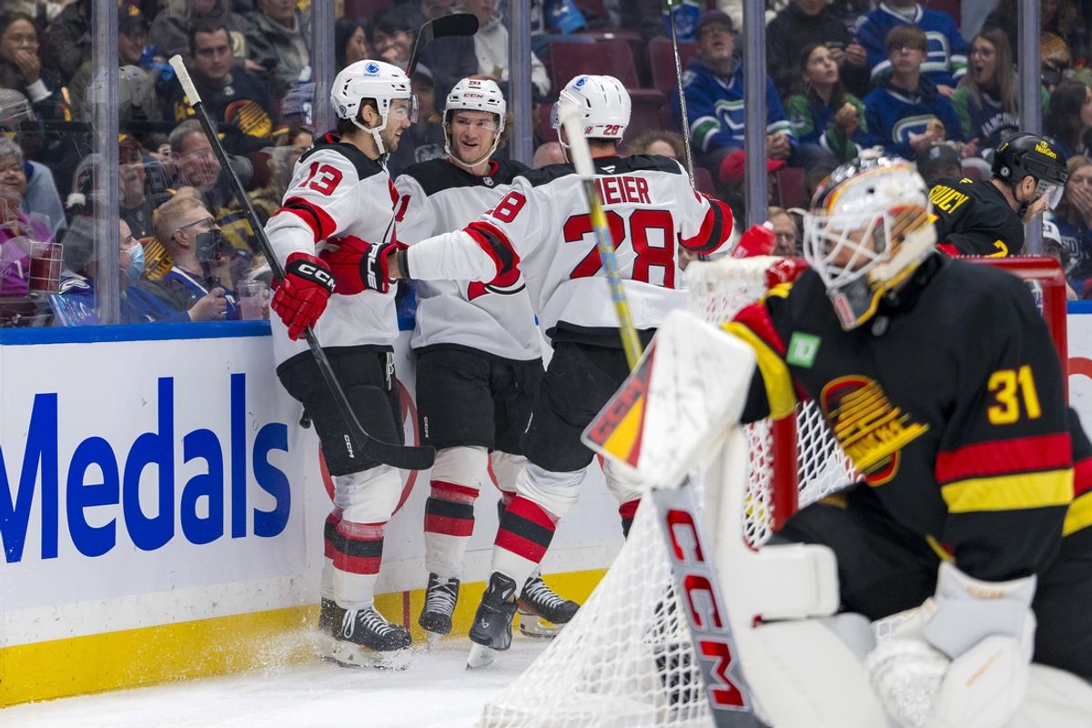 Oct 30, 2024; Vancouver, British Columbia, CAN; New Jersy Devils forward Nico Hischier (13) and forward Dawson Mercer (91) and forward Timo Meier (28) celebrate Hischier’s goal against the Vancouver Canucks during the first period at Rogers Arena. Mandatory Credit: Bob Frid-Imagn Images