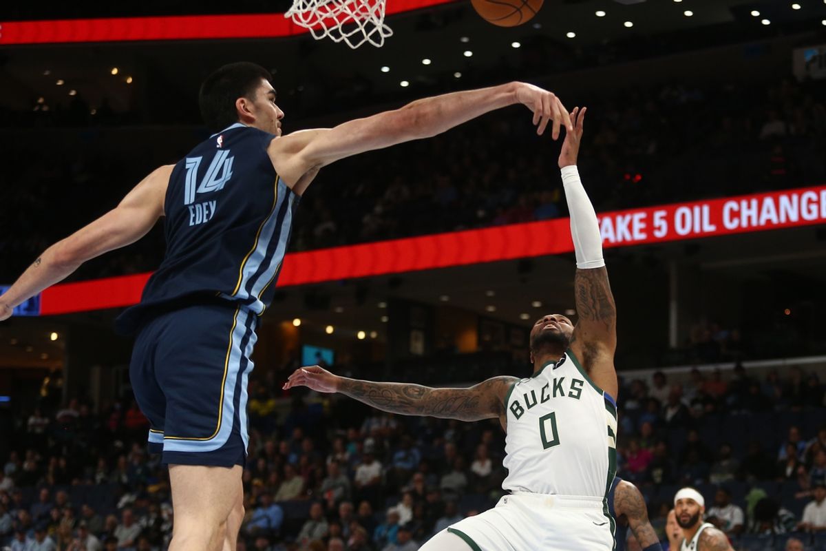 Oct 31, 2024; Memphis, Tennessee, USA; Memphis Grizzlies center Zach Edey (14) blocks the shot attempt by Milwaukee Bucks guard Damian Lillard (0) during the first half at FedExForum. Mandatory Credit: Petre Thomas-Imagn Images