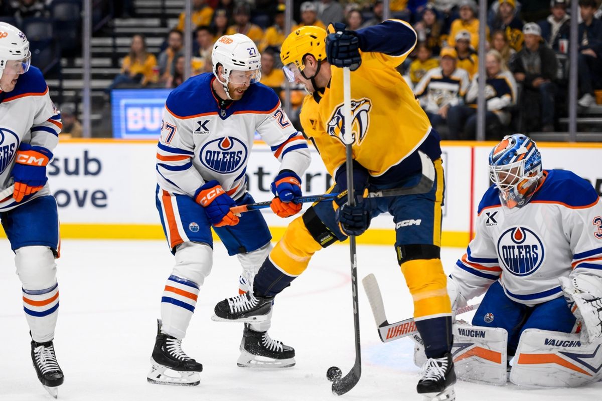 Oct 31, 2024; Nashville, Tennessee, USA;  Edmonton Oilers goaltender Calvin Pickard (30) blocks the shot of Nashville Predators center Ryan O'Reilly (90) during the first period at Bridgestone Arena. Mandatory Credit: Steve Roberts-Imagn Images