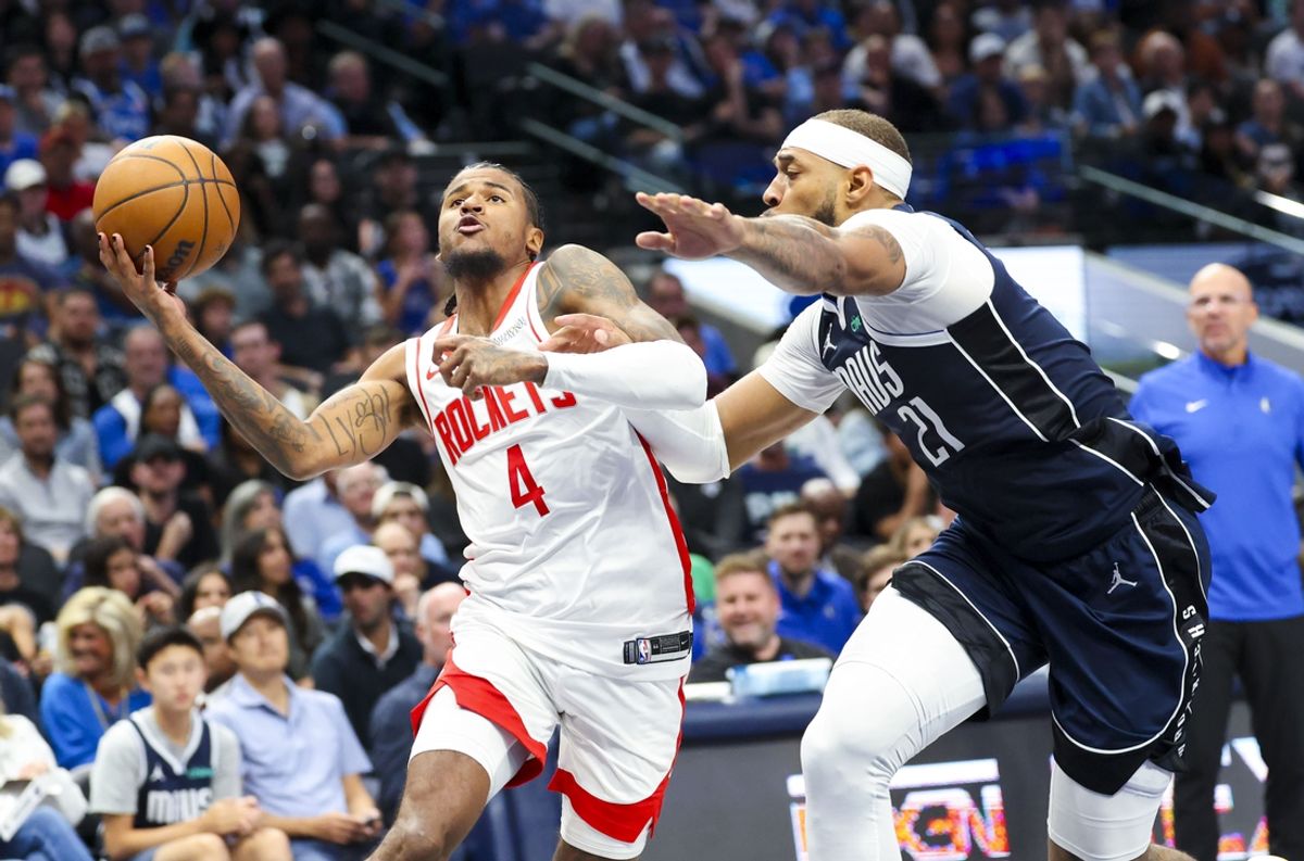 Oct 31, 2024; Dallas, Texas, USA;  Houston Rockets guard Jalen Green (4) drives to the basket as Dallas Mavericks center Daniel Gafford (21) defends during the first half at American Airlines Center. Mandatory Credit: Kevin Jairaj-Imagn Images