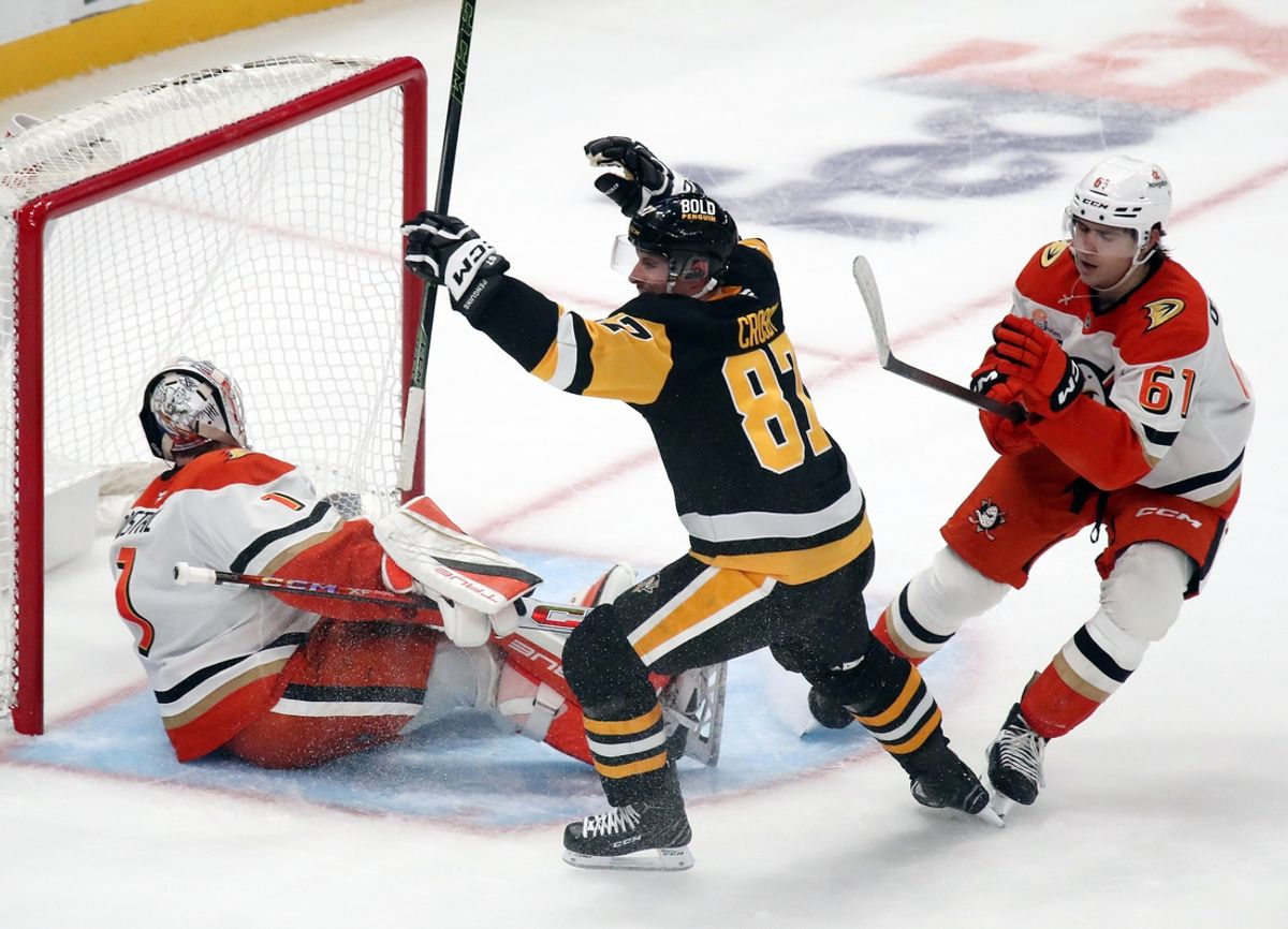 Oct 31, 2024; Pittsburgh, Pennsylvania, USA;  Pittsburgh Penguins center Sidney Crosby (87) reacts after scoring the game winning goal against Anaheim Ducks goaltender Lukas Dostal (1) in overtime at PPG Paints Arena. Mandatory Credit: Charles LeClaire-Imagn Images