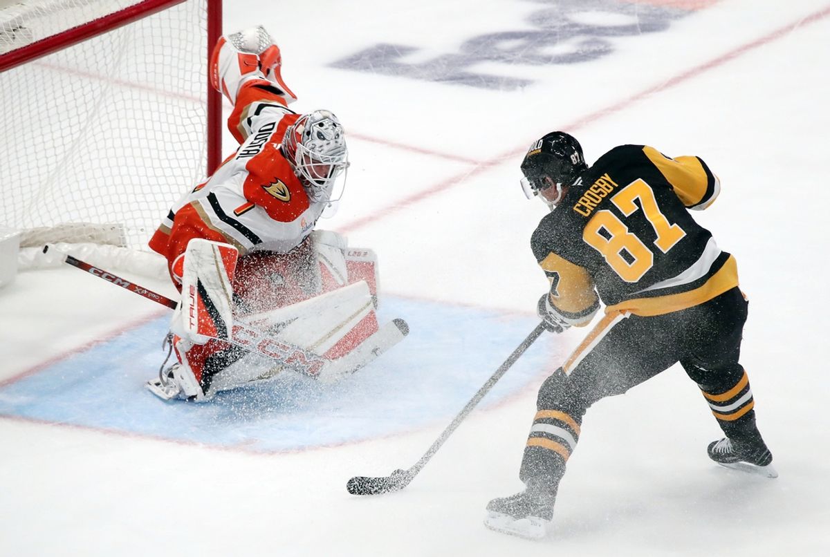 Oct 31, 2024; Pittsburgh, Pennsylvania, USA;  Pittsburgh Penguins center Sidney Crosby (87) shoots and scores the game winning goal against Anaheim Ducks goaltender Lukas Dostal (1) in overtime at PPG Paints Arena. Mandatory Credit: Charles LeClaire-Imagn Images