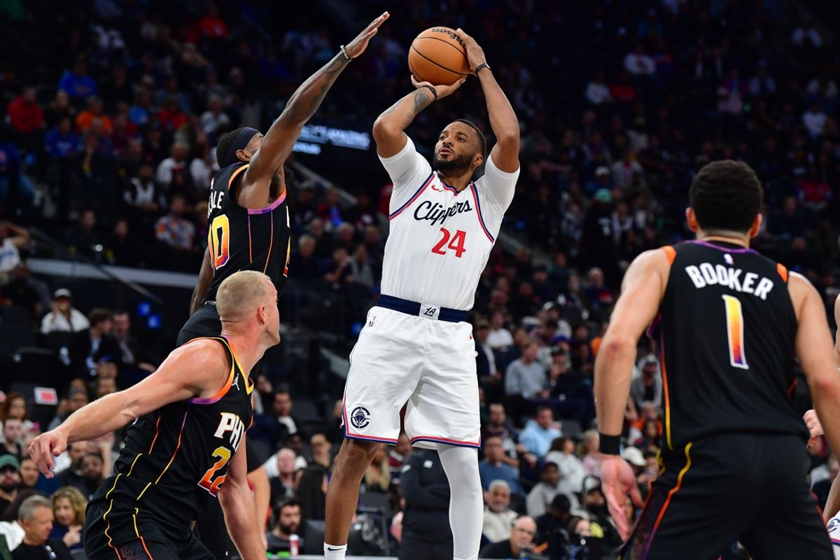 Oct 31, 2024; Inglewood, California, USA; Los Angeles Clippers guard Norman Powell (24) shoots against Phoenix Suns forward Royce O'Neale (00) during the second half at Intuit Dome. Mandatory Credit: Gary A. Vasquez-Imagn Images