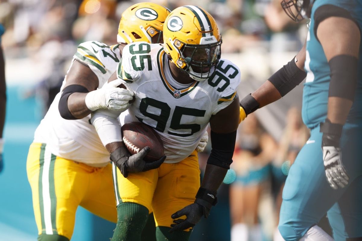 Oct 27, 2024; Jacksonville, Florida, USA; Green Bay Packers defensive lineman Devonte Wyatt (95) recovers a fumble against the Jacksonville Jaguars during the second quarter at EverBank Stadium. Mandatory Credit: Morgan Tencza-Imagn Images