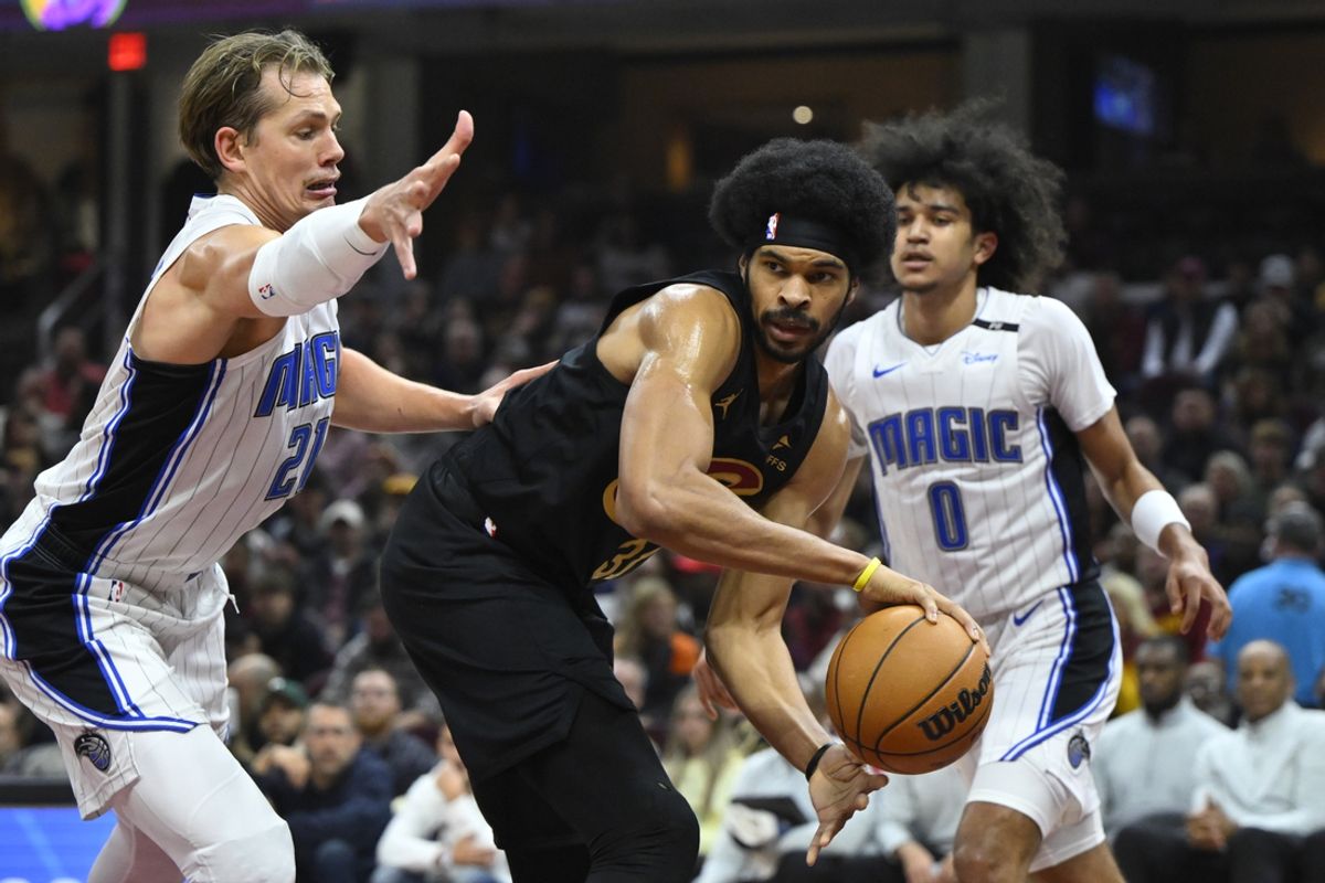 Nov 1, 2024; Cleveland, Ohio, USA; Cleveland Cavaliers center Jarrett Allen (31) looks to pass beside Orlando Magic center Moritz Wagner (21) and guard Anthony Black (0) in the first quarter at Rocket Mortgage FieldHouse. Mandatory Credit: David Richard-Imagn Images