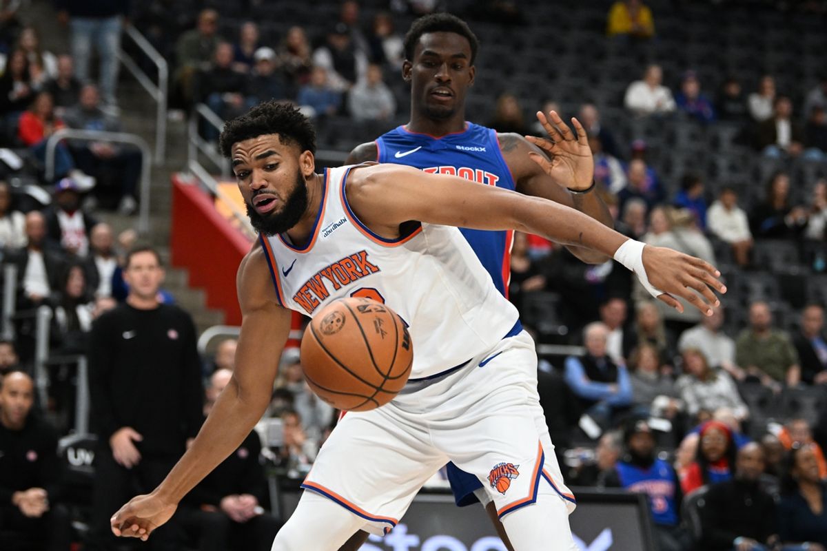 Nov 1, 2024; Detroit, Michigan, USA; New York Knicks center Karl-Anthony Towns (32) battles for a loose ball with Detroit Pistons center Jalen Duren (0) in the first quarter at Little Caesars Arena. Mandatory Credit: Lon Horwedel-Imagn Images
