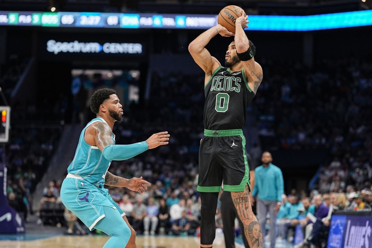 Nov 1, 2024; Charlotte, North Carolina, USA; Boston Celtics forward Jayson Tatum (0) shoots a jumper defended by Charlotte Hornets forward Miles Bridges (0) during the second quarter at the Spectrum Center. Mandatory Credit: Jim Dedmon-Imagn Images