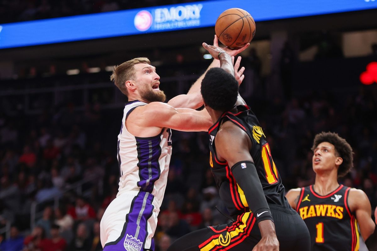 Nov 1, 2024; Atlanta, Georgia, USA; Sacramento Kings forward Domantas Sabonis (11) shoots past Atlanta Hawks forward Onyeka Okongwu (17) in the second quarter at State Farm Arena. Mandatory Credit: Brett Davis-Imagn Images