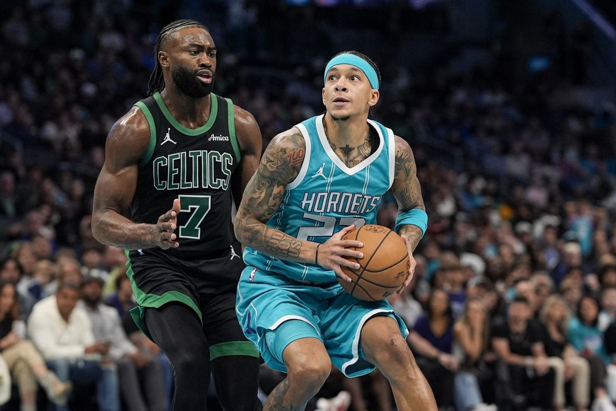 Nov 1, 2024; Charlotte, North Carolina, USA; Charlotte Hornets guard Tre Mann (23) looks to shoot guarded by Boston Celtics guard Jaylen Brown (7) during the second half at the Spectrum Center. Mandatory Credit: Jim Dedmon-Imagn Images
