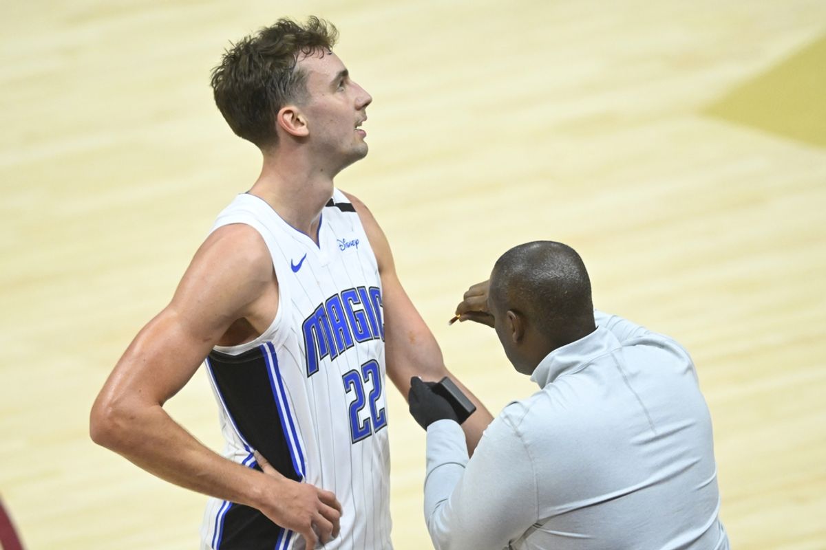 Nov 1, 2024; Cleveland, Ohio, USA; A trainer looks at the arm of Orlando Magic forward Franz Wagner (22) in the third quarter against the Cleveland Cavaliers at Rocket Mortgage FieldHouse. Mandatory Credit: David Richard-Imagn Images