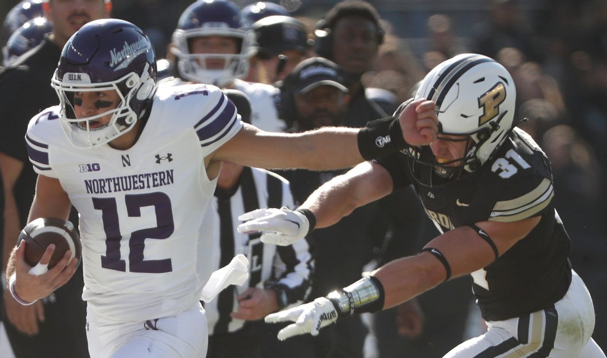 Purdue Boilermakers defensive back Dillon Thieneman (31) pushes Northwestern Wildcats quarterback Jack Lausch (12) out of bounds Saturday, Nov. 2, 2024, during the NCAA football game at Ross-Ade Stadium in West Lafayette, Ind.