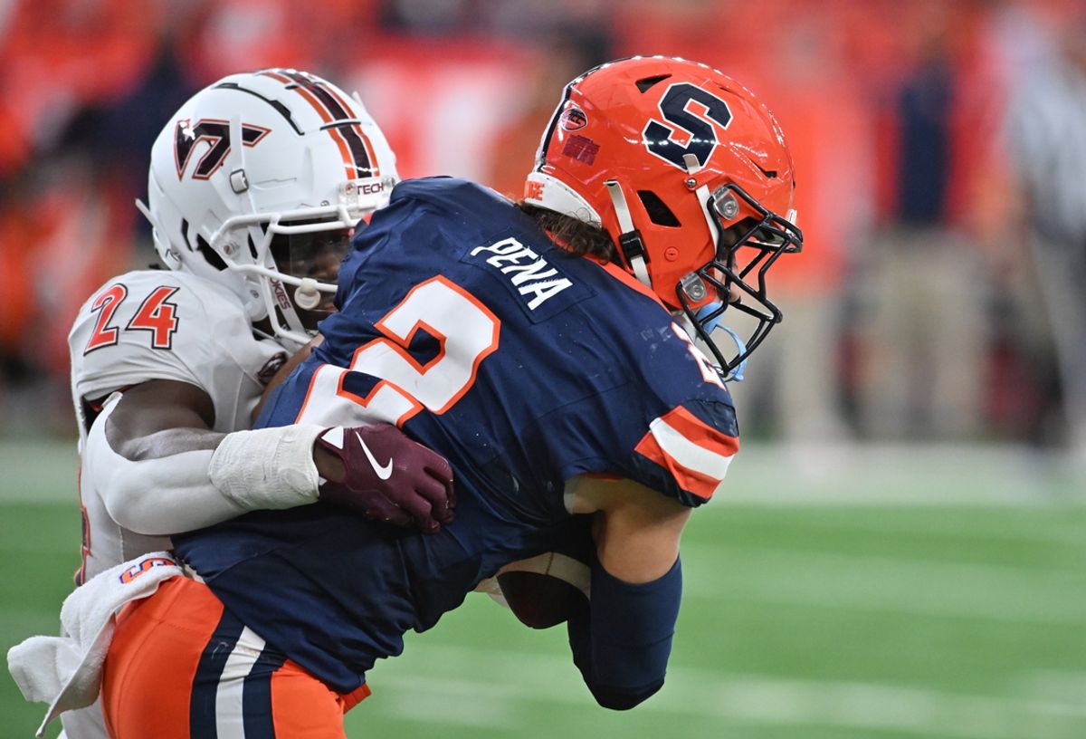 Nov 2, 2024; Syracuse, New York, USA; Virginia Tech Hokies linebacker Jaden Keller (24) makes a tackle on Syracuse Orange wide receiver Trebor Pena (2) in the second quarter at JMA Wireless Dome. Mandatory Credit: Mark Konezny-Imagn Images