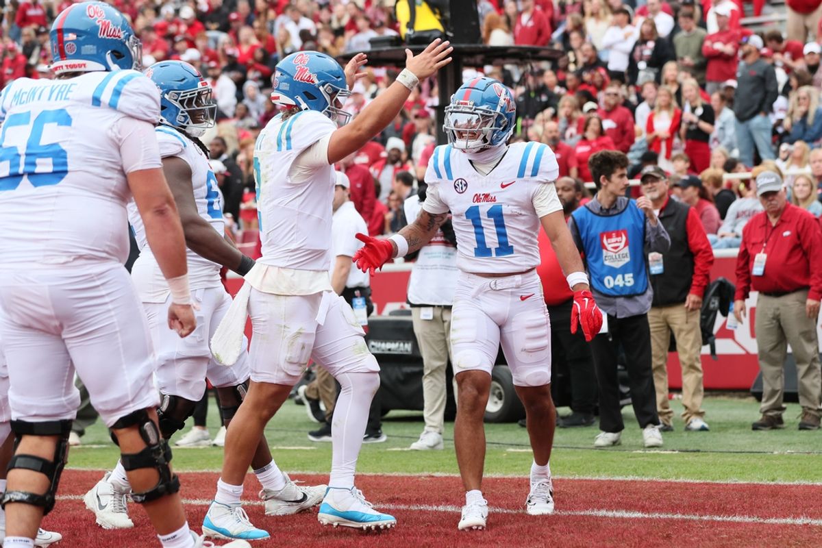Nov 2, 2024; Fayetteville, Arkansas, USA; Ole Miss Rebels wide receiver Jordan Watkins (11) celebrates with quarterback Jaxson Dart (2) after catching a pass for a touchdown in the second quarter against the Arkansas Razorbacks at Donald W. Reynolds Razorback Stadium. Mandatory Credit: Nelson Chenault-Imagn Images