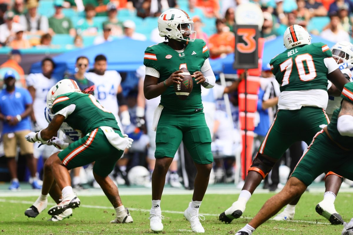 Nov 2, 2024; Miami Gardens, Florida, USA; Miami Hurricanes quarterback Cam Ward (1) looks for a passing option against the Duke Blue Devils during the second quarter at Hard Rock Stadium. Mandatory Credit: Sam Navarro-Imagn Images